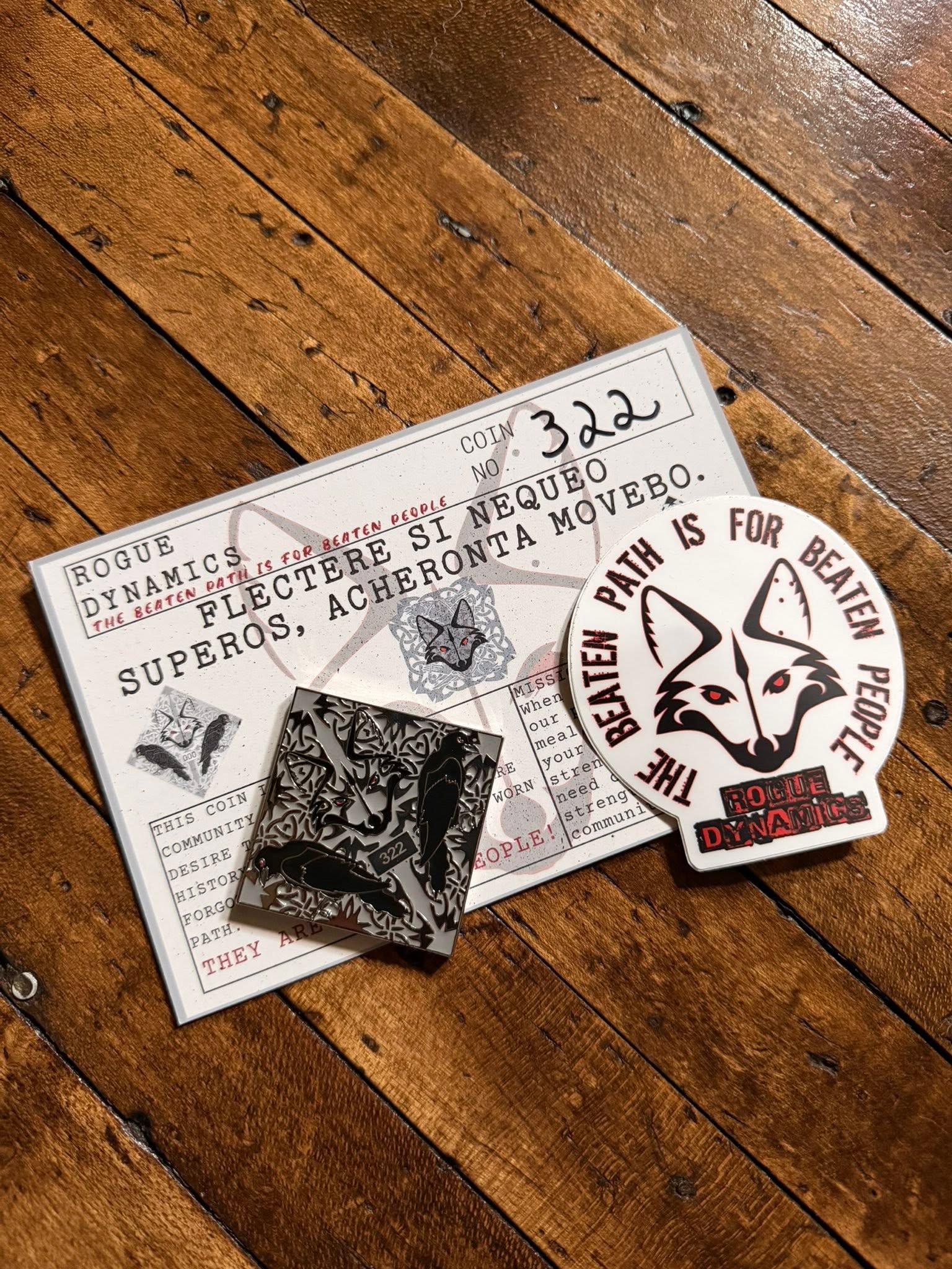 Rogue Dynamics Labyrinth Coin 2.0, numbered, with its mission card and beaten-path fox sticker