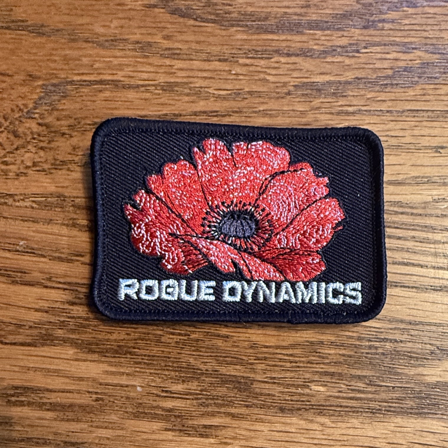 Rogue Dynamics poppy morale patch with hook and loop backing, front view